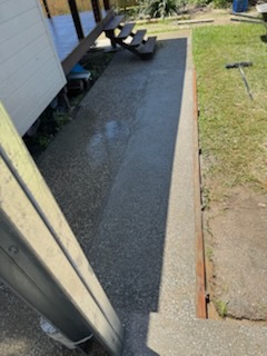 Concrete path poured down the side of a house