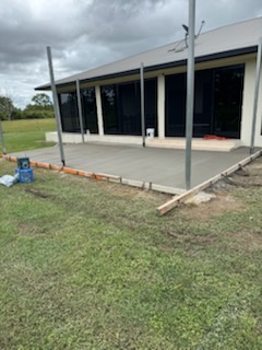 New concrete patio slab alongside a home